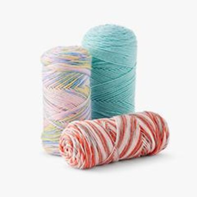 three skeins of yarn in assorted colors